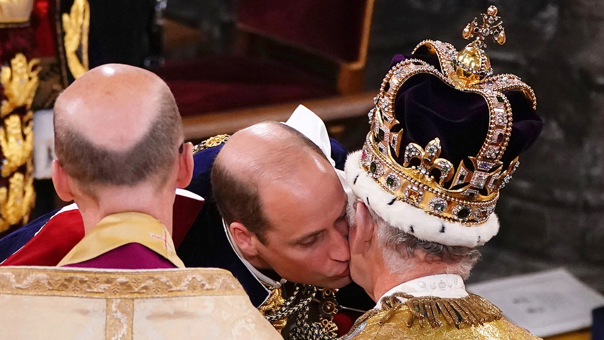 Prince William kissing his father King Charles on the cheek