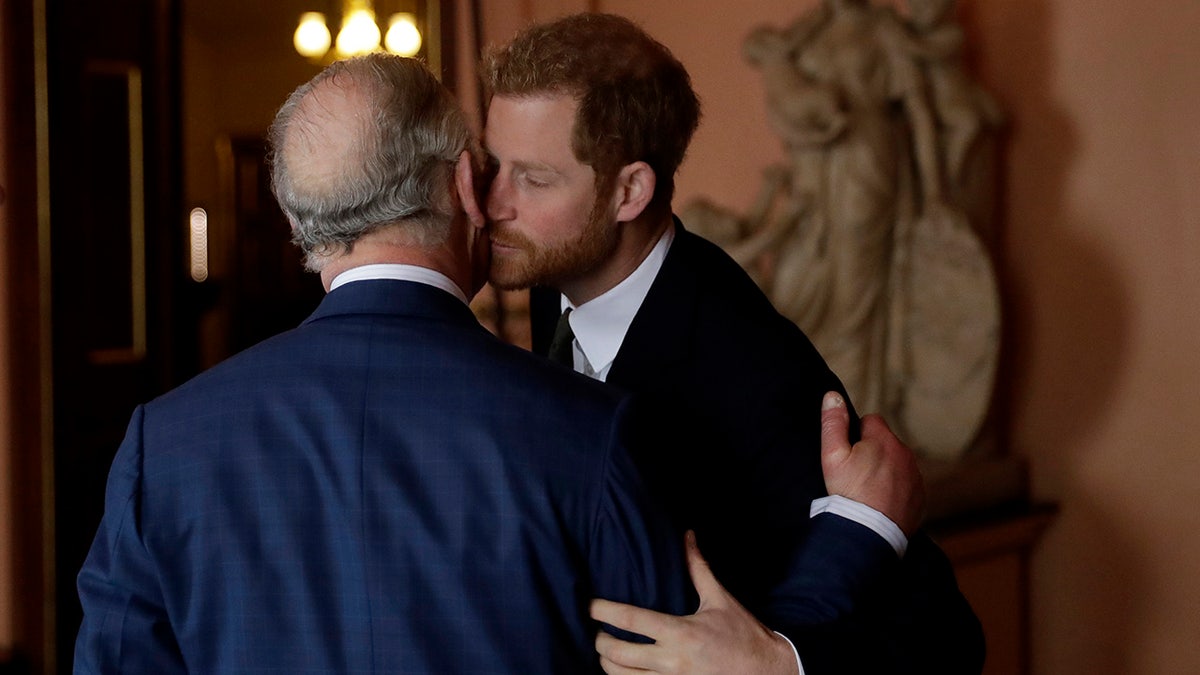 Prince Harry kissing his father King Charles on the cheek