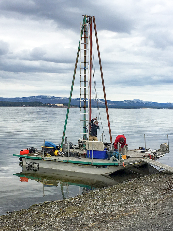 A photograph of two scientists on a coring platform on Yellowstone Lake