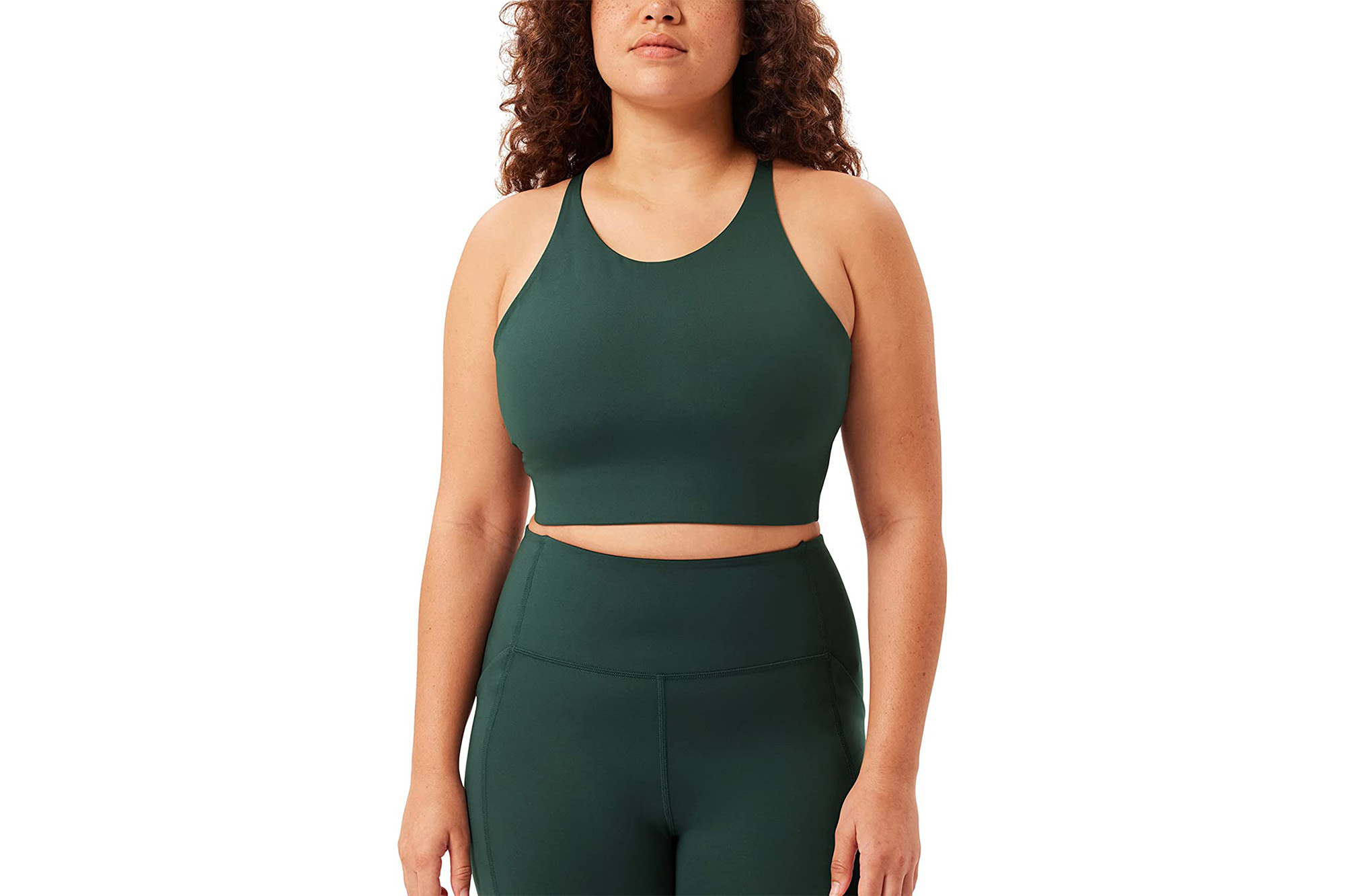A model in a dark green sports bra and matching leggings