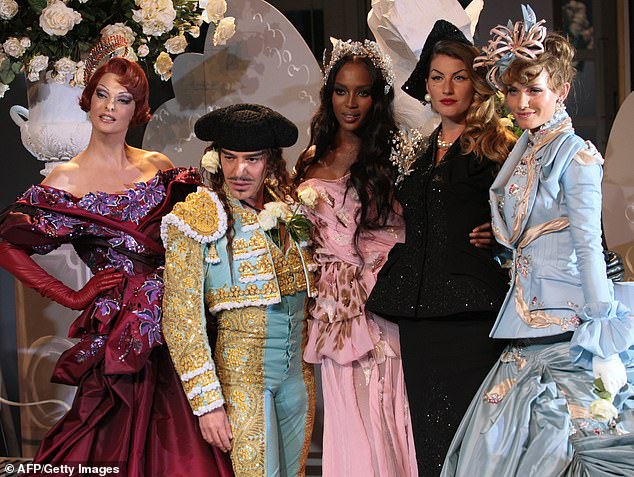 John Galliano poses with Linda Evangelista (L), Naomi Campbell (3rd R) and Gisele Bundchen (2nd R) at the end of the Christian Dior Fall/Winter 2007 Haute Couture collection show in Paris