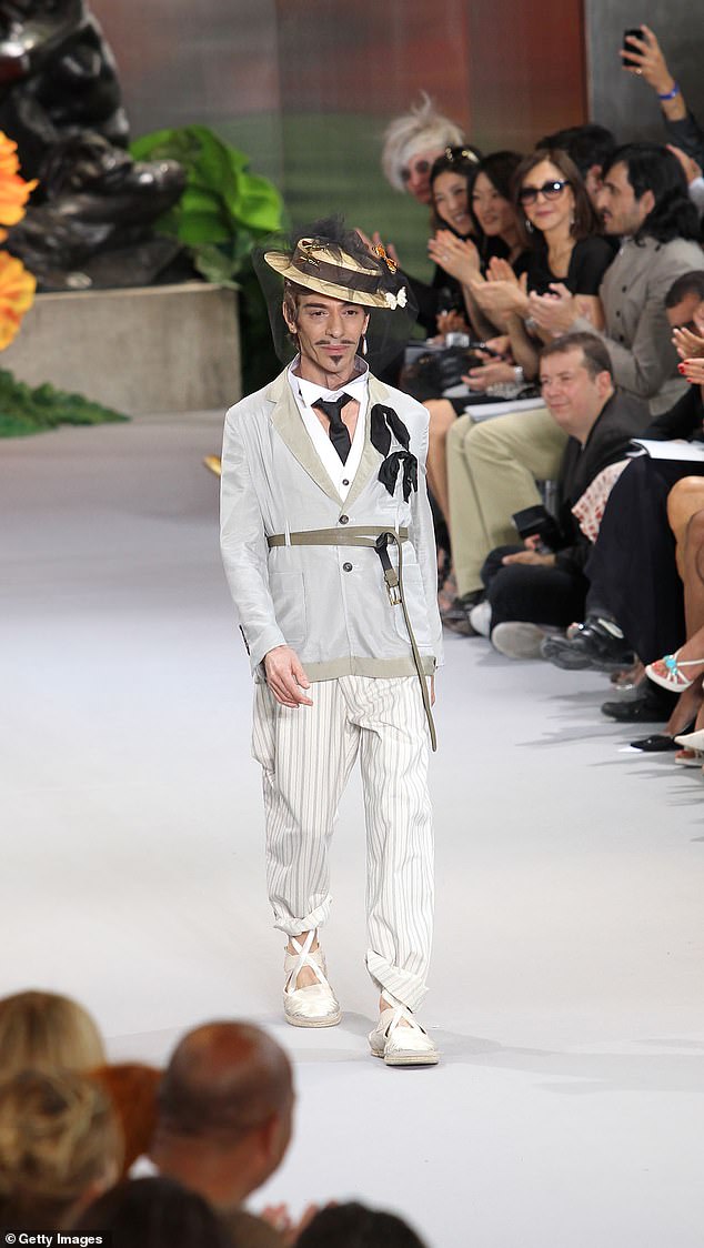 John Galliano walks the runway at the end of the Dior show as part of the Paris Haute Couture Fashion Week Fall/Winter 2011 at Musee Rodin on July 5, 2010