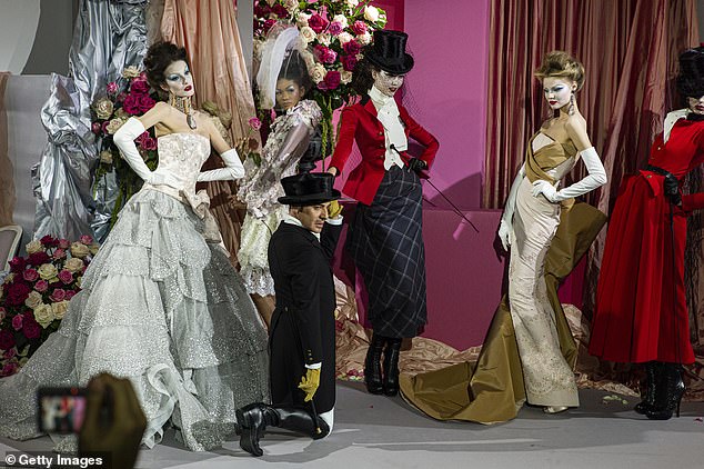 John Galliano pictured with models wearing his creations for the luxury fashion brand Dior during the Autumn/Winter Haute Couture show on January 25, 2010