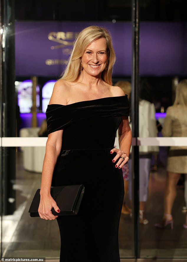The television presenter carried an oversized black clutch