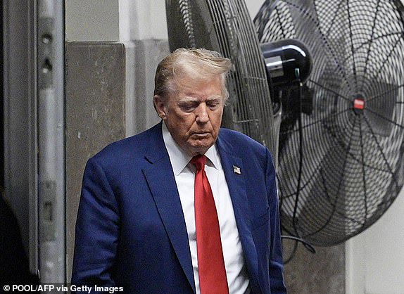 Former US President Donald Trump walks to the courtroom after a break in his trial for allegedly covering up hush money payments linked to extramarital affairs, at Manhattan Criminal Court in New York City, on May 10, 2024. Trump is accused of falsifying business records in a scheme to cover up an alleged sexual encounter with adult film actress Stormy Daniels to shield his 2016 election campaign from adverse publicity. (Photo by Curtis Means / POOL / AFP) (Photo by CURTIS MEANS/POOL/AFP via Getty Images)