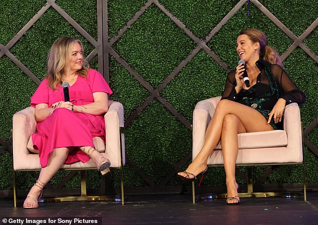 Lively was also seen talking on stage during the panel discussion with Colleen Hoover - who donned a hot pink dress that fell down past her knees