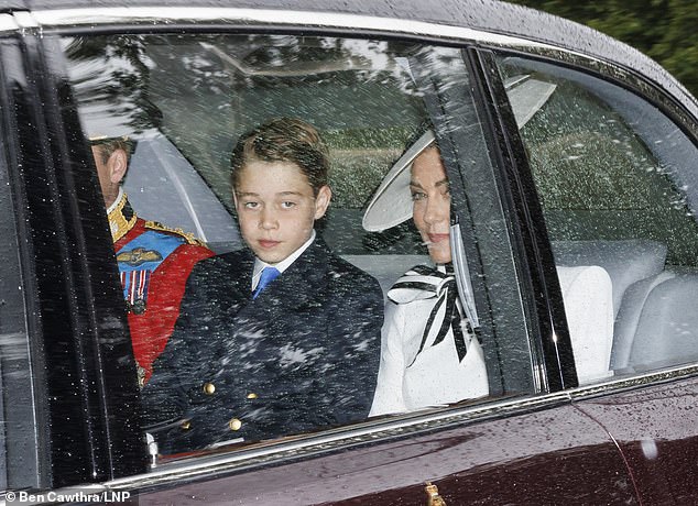 George sits between his mother Kate and father Prince William in the car in London today