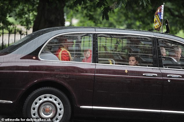 Princess Charlotte looks out the window as the family arrive at Buckingham Palace today