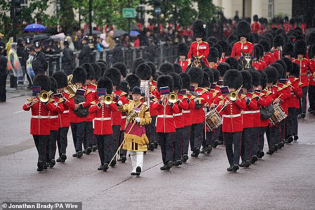 The Band of the Grenadier Guards march along The Mall towards Horse Guards Parade today