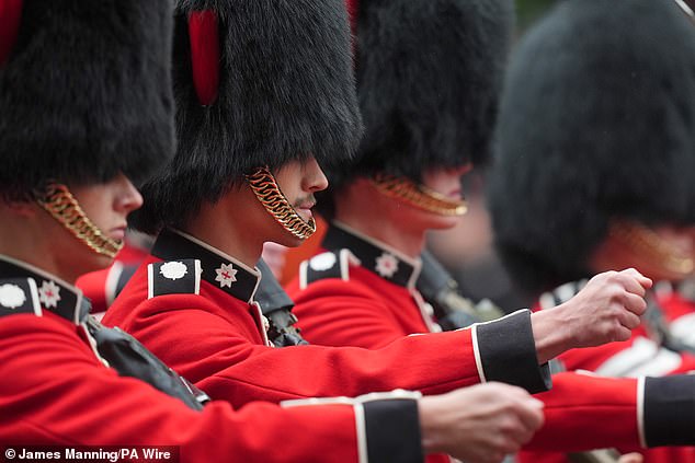 Members of the Irish Guards march along The Mall towards Horse Guards Parade today