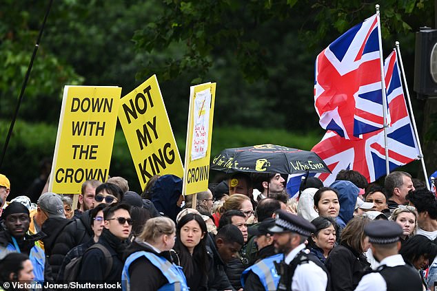 Republic protesters hold up placards on The Mall ahead of Trooping the Colour this morning