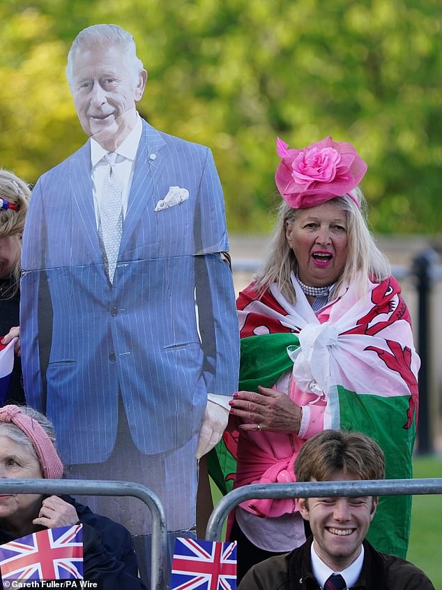 Royal fans on the The Mall with a cardboard cutout of King Charles III this morning