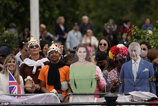 Royal fans on the The Mall with cardboard cutouts of the Princess of Wales and the King today