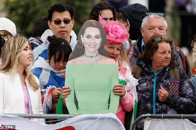 Royal fans on the The Mall with cardboard cutouts ahead of Trooping the Colour today