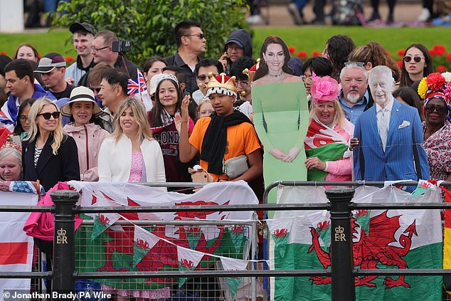 Royal fans on the The Mall with cardboard cutouts of the Princess of Wales and the King today