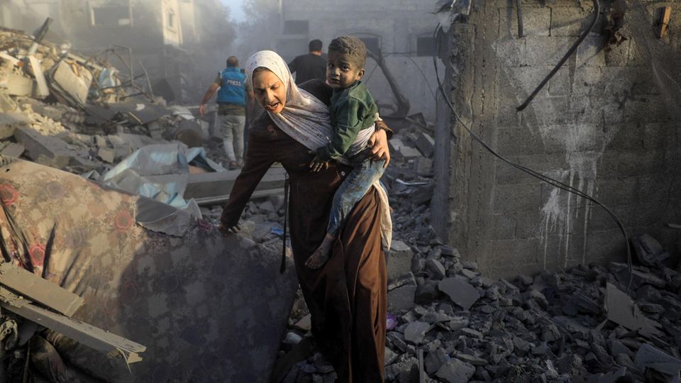 Mother and child escape to safety after an Israeli airstrike