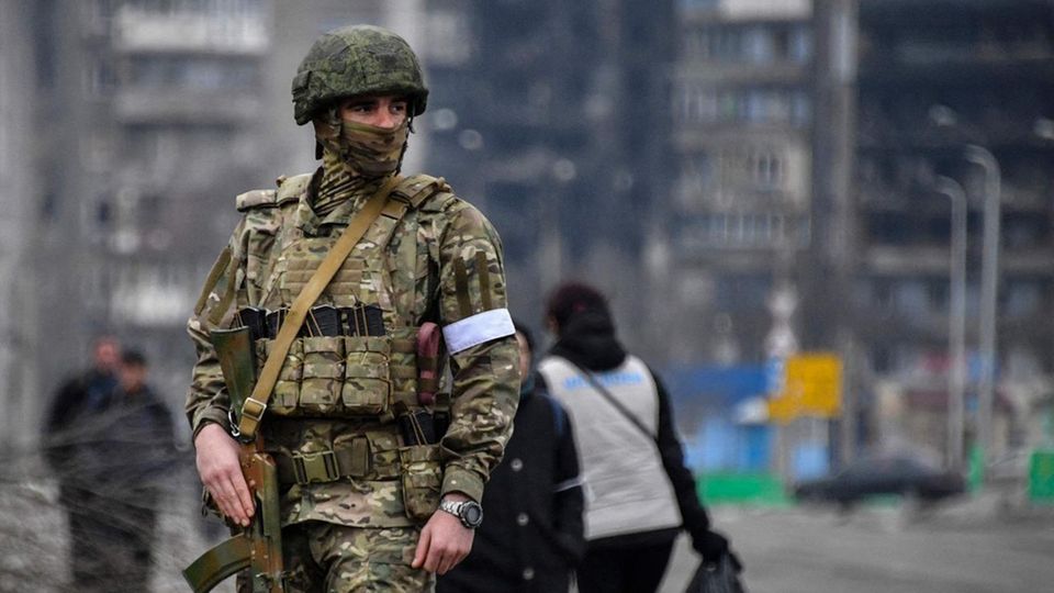 A Russian soldier patrols Mariupol