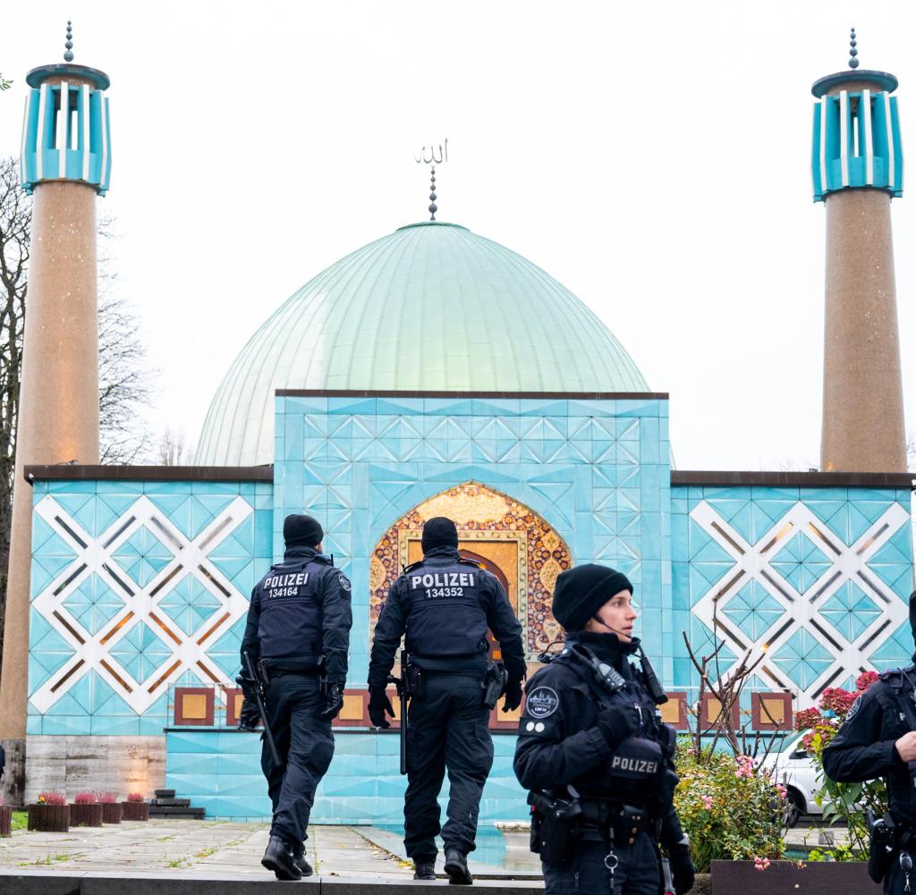 Police officers in front of a mosque