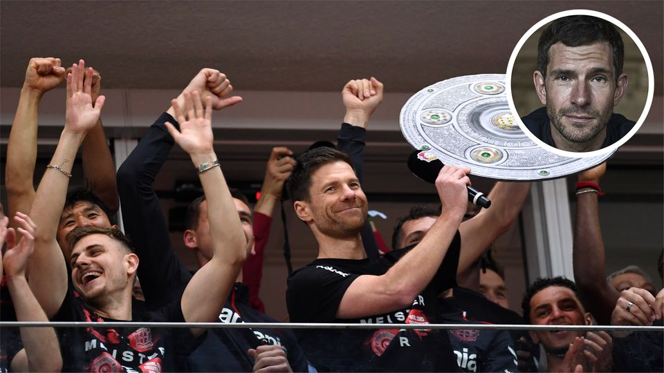 Coach Xabi Alonso and his players celebrate with a replica of the championship trophy