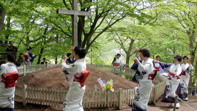 On the trail of the secret: Traditionally dressed Japanese women dance around the "Tomb of Christ".