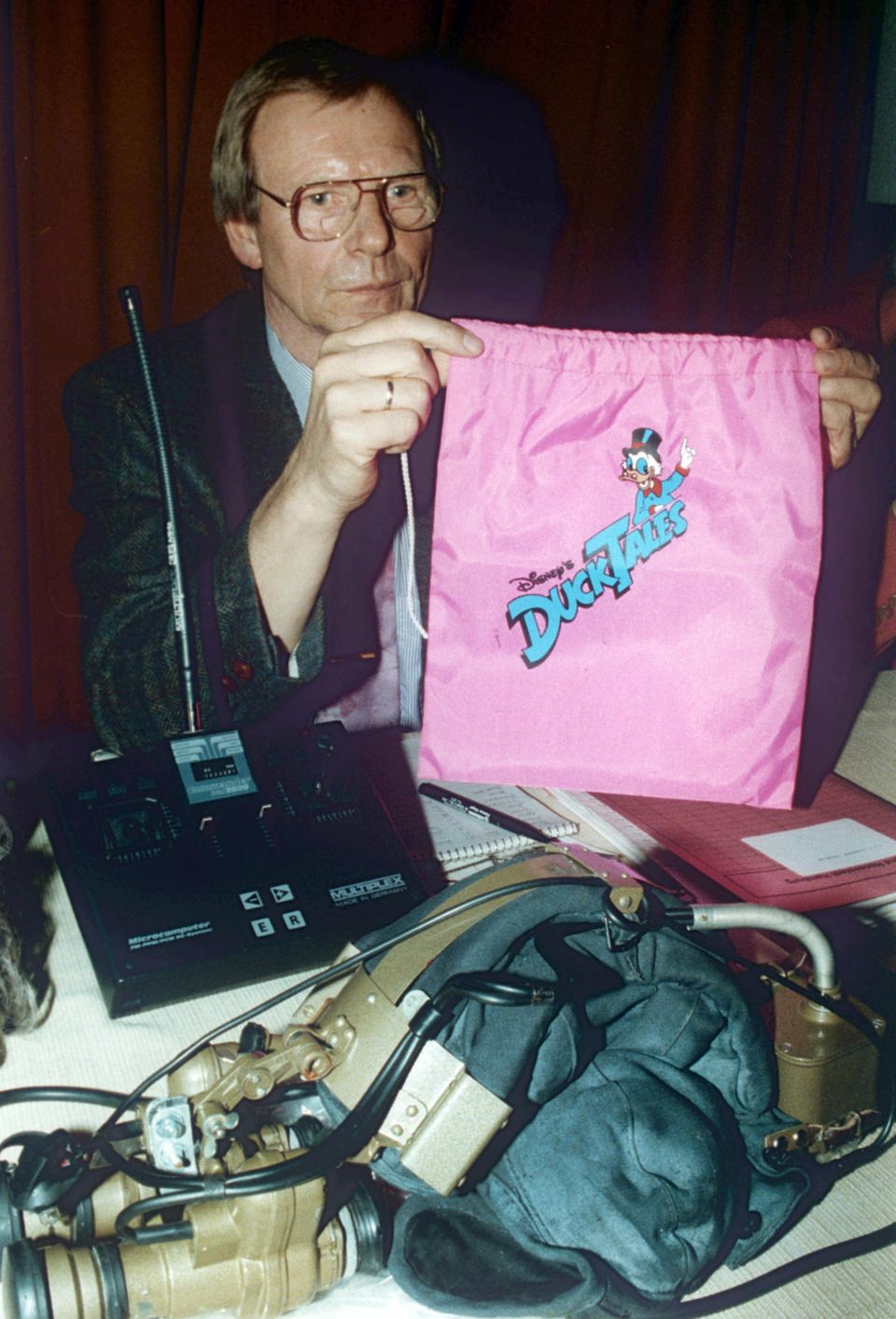 Detective Inspector Arthur Heins shows a pink bag with a Duck Tales print on it as evidence