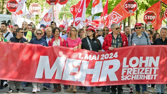 Demonstrators hold a banner with the inscription "May 1, 2024 More wages, free time, security" in Hamburg-Altona.  © dpa Photo: Georg Wendt
