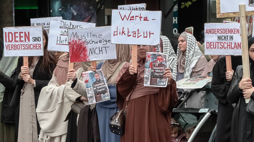 Veiled Muslims protest against alleged Islamophobia in Germany.  A group of Islamists called