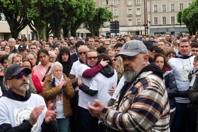 Matisse's father (center) comforts a woman during the white march, in Châteauroux, May 4, 2024. 