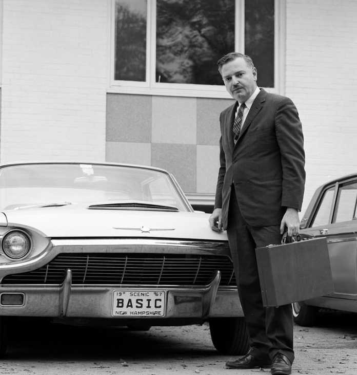 John Kemeny in front of a sports car
