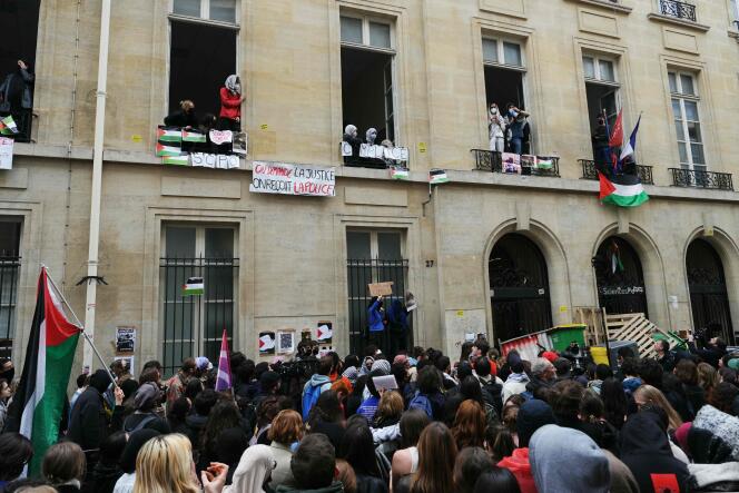 Demonstrators in front of Sciences Po Paris as students occupy one of the buildings, with a barricade blocking the entrance, in support of the Palestinians, April 26, 2024.