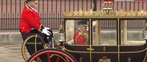 King Charles and Queen Camilla, on board a carriage, engage in the Trooping The Color parade on June 15, 2024